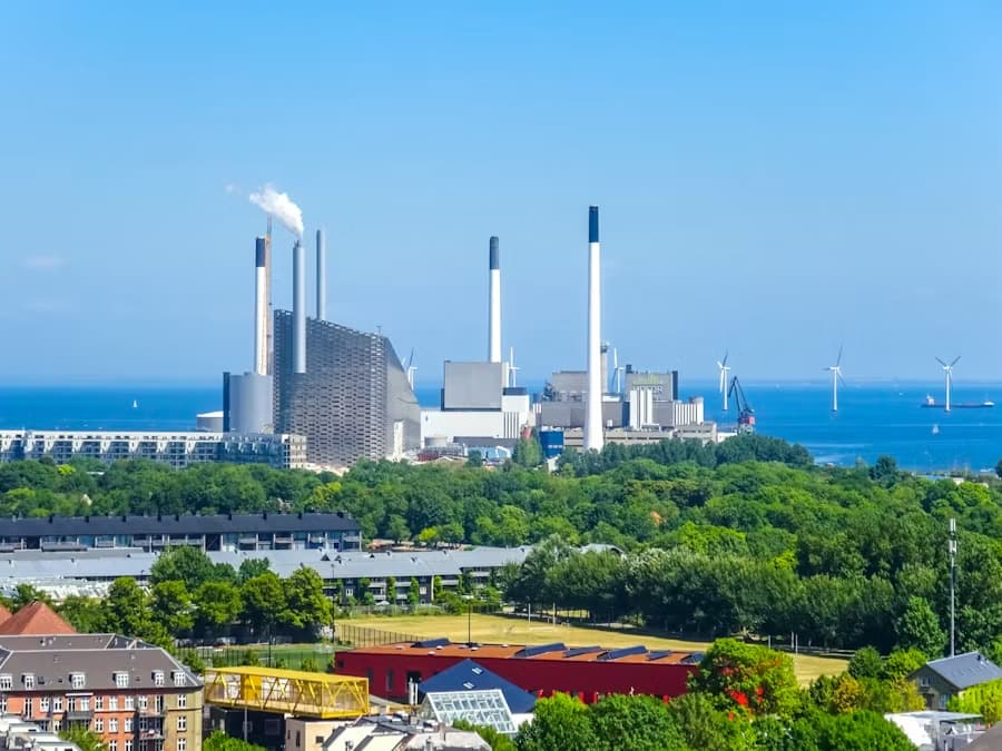 Coastal energy plant with offshore wind turbines on the horizon