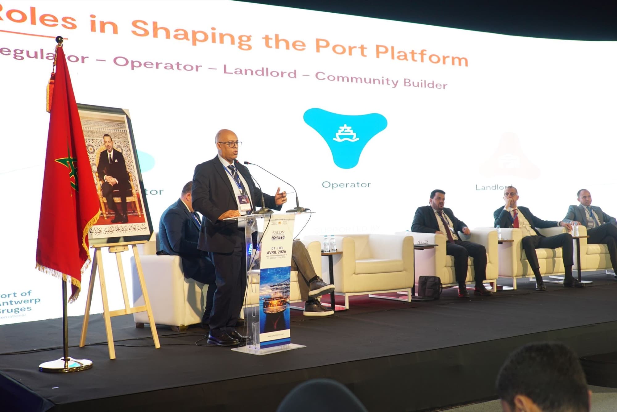 Youssef Imghi speaking at the lectern during SIPORTS 2026 in El Jadida, April 2026